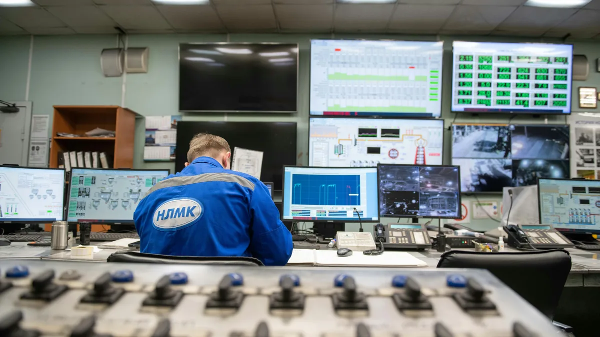 Operator monitoring multiple screens in a control room