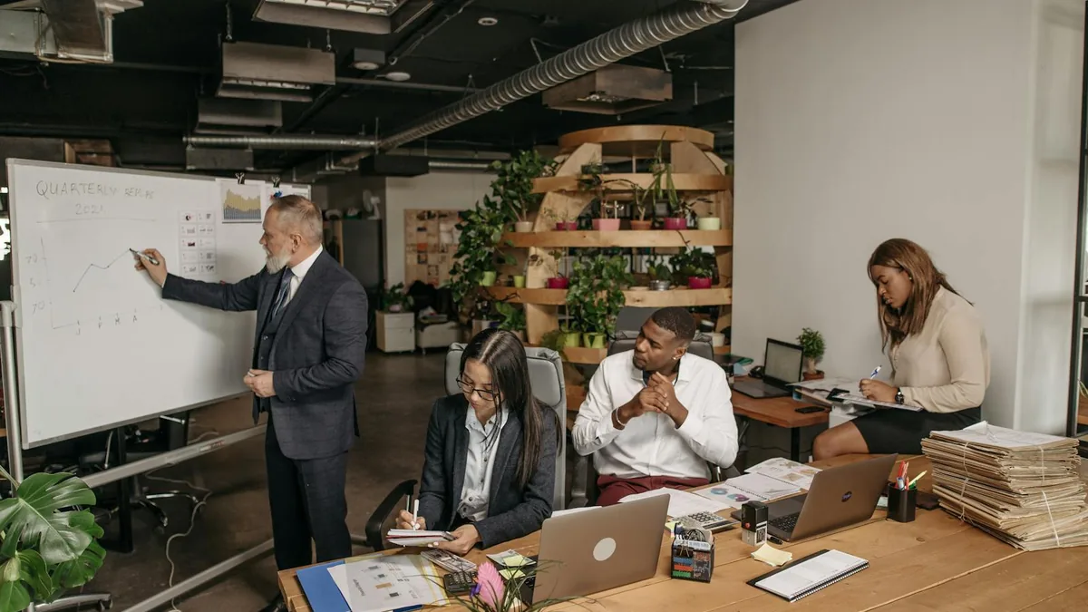 Office team discussing controls near a whiteboard