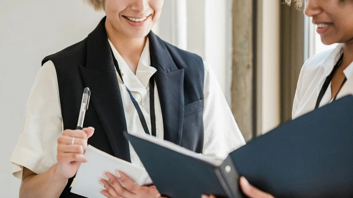 Two people reviewing documents together during an office meeting